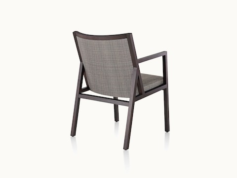An Ascribe side chair with gray upholstery and a wood frame with a dark finish, viewed from behind at an angle.