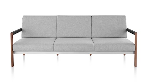 A Brabo Sofa with light gray upholstery, leather and metal accents, and an exposed wood frame. Viewed from the front.