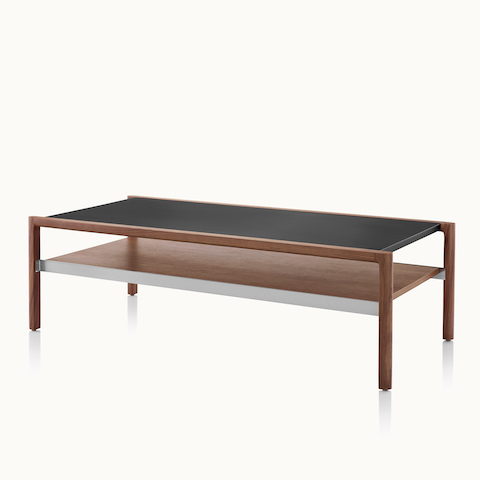 A Brabo coffee table with a black leather-wrapped top and walnut lower shelf, viewed at an angle. Select to go to the Brabo Tables product page.