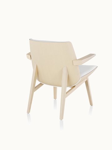 A low-back Clamshell Lounge Chair with four wood legs, viewed from behind at an angle to show the veneer shell.