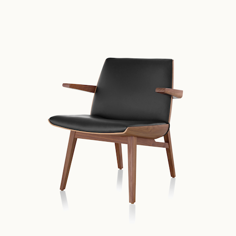 Angled view of a low-back Clamshell Lounge Chair with black leather upholstery. Select to go to the Clamshell Lounge Chair product page.
