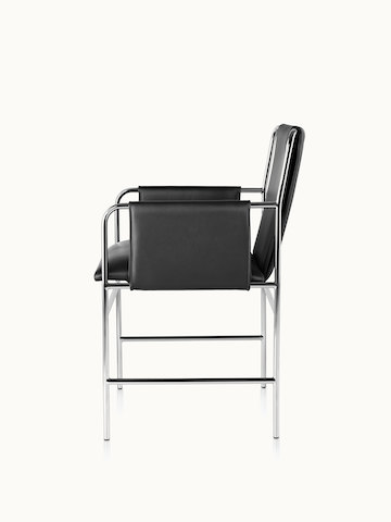 Side view of an Envelope side chair with black leather upholstery and a tubular steel frame.