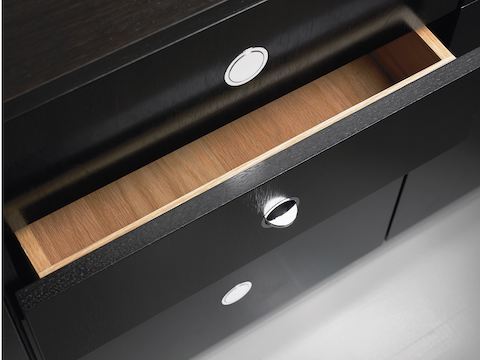 Overhead view of a partially open drawer in an H Frame Storage credenza, showing the flush-mounted Flip pulls.