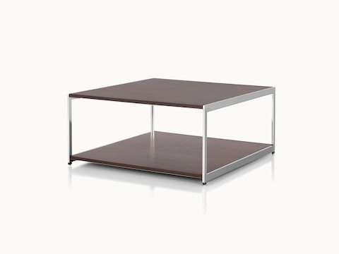 Angled view of an H Frame coffee table with a metal frame and wood surfaces in a dark finish.