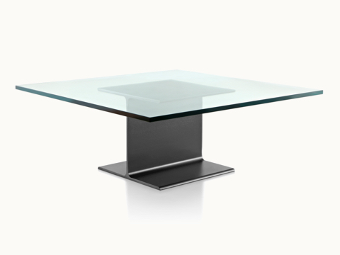 Angled view of a square I Beam coffee table with a glass top and black cast-aluminum pedestal.