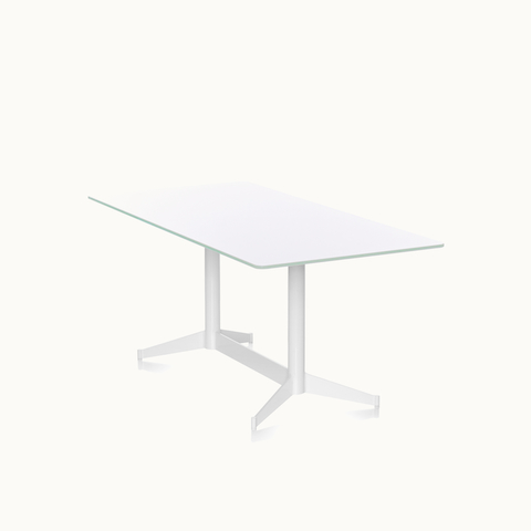 Angled view of a rectangular MP Table with a white back-painted glass top and white base. Select to go to the MP Tables product page.