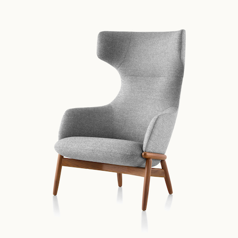 Angled view of a wing-back Reframe lounge chair with light gray upholstery. Select to go to the Reframe Lounge Seating product page.