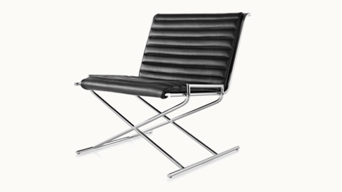 Angled view of a Sled lounge chair with black leather upholstery and an X-shaped steel frame.