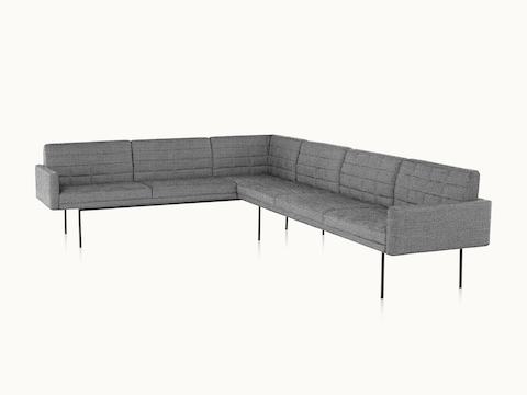 A quilted Tuxedo Component sectional upholstered in gray fabric.